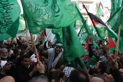 Palestinian supporters of Hamas attend a rally marking the 25th anniversary of the Islamist movement's foundation