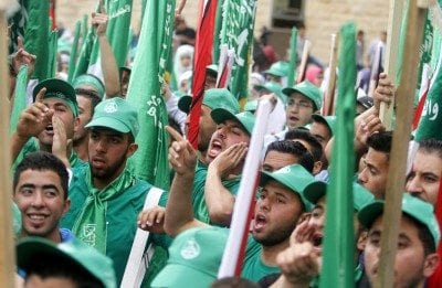 Palestinian supporters of the Islamic Hamas movement attend a rally prior to the Student Council elections at Birzeit University
